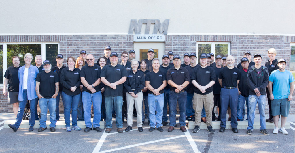 The NTM team outside the Main Office